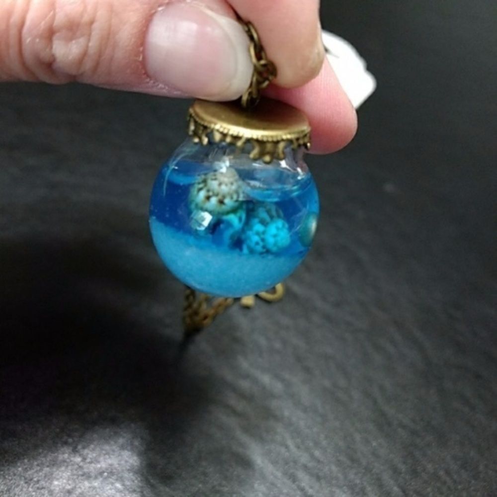 Gold tone ocean in a bottle necklace blue Bow